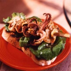 Charred Squid Skewers on Garlic Toast with Arugula